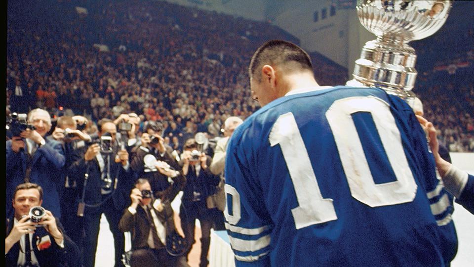 George Armstrong, captain of the Leafs from 1957-69, holding the Stanley Cup in front of reporters at Maple Leaf Gardens on the day the Leafs became the champions of the 1967 Stanley Cup Final (May 2nd, 1967)