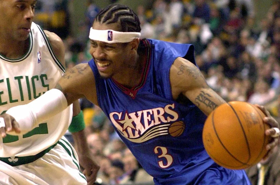 Allen Iverson of the Philadelphia 76ers drives to the basket against Bimbo Coles of the Boston Celtics 10 April 2003 at the Fleet Center in Boston, Massachusetts. AFP PHOTO/John MOTTERN (Photo by JOHN MOTTERN / AFP) (Photo by JOHN MOTTERN/AFP via Getty Images)