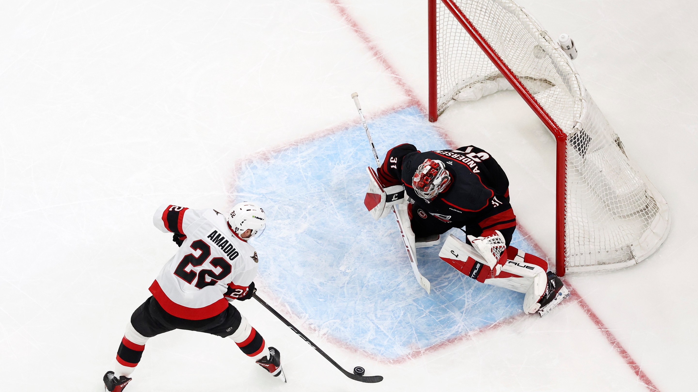 Frederik Andersen #31 of the Carolina Hurricanes makes a save against Michael Amadio