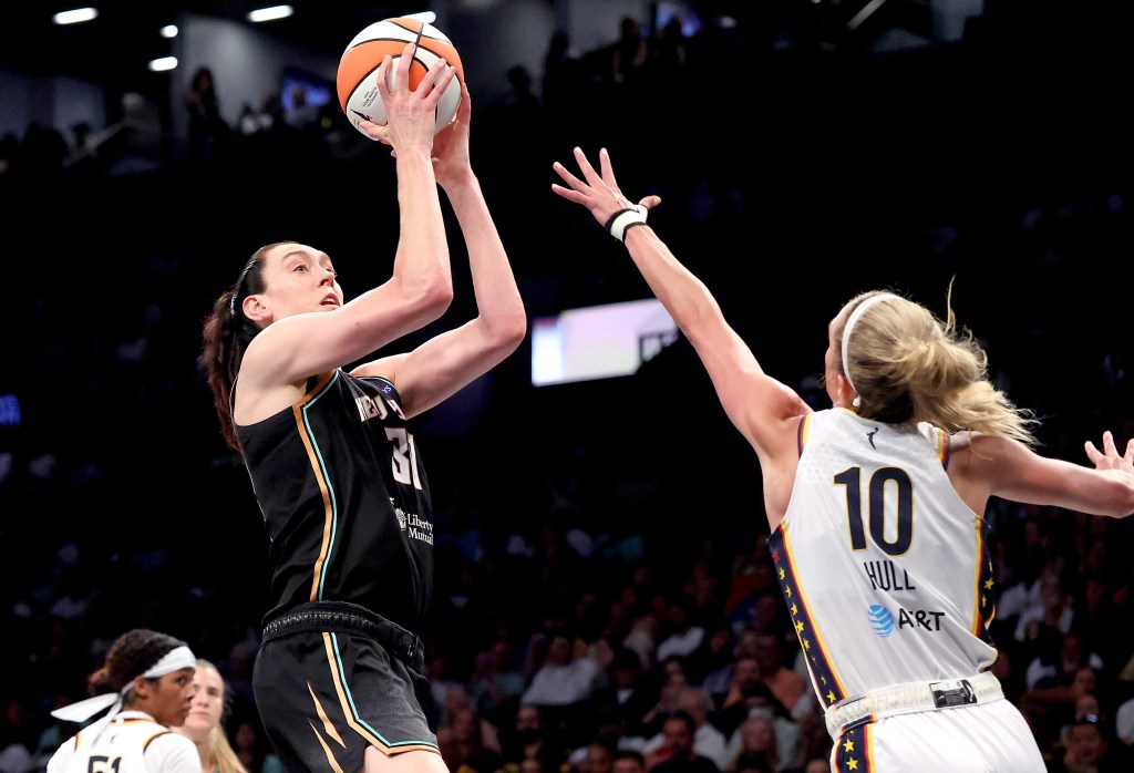 Breanna Stewart of the New York Liberty shoots over Lexie Hull of the Indiana Fever.
