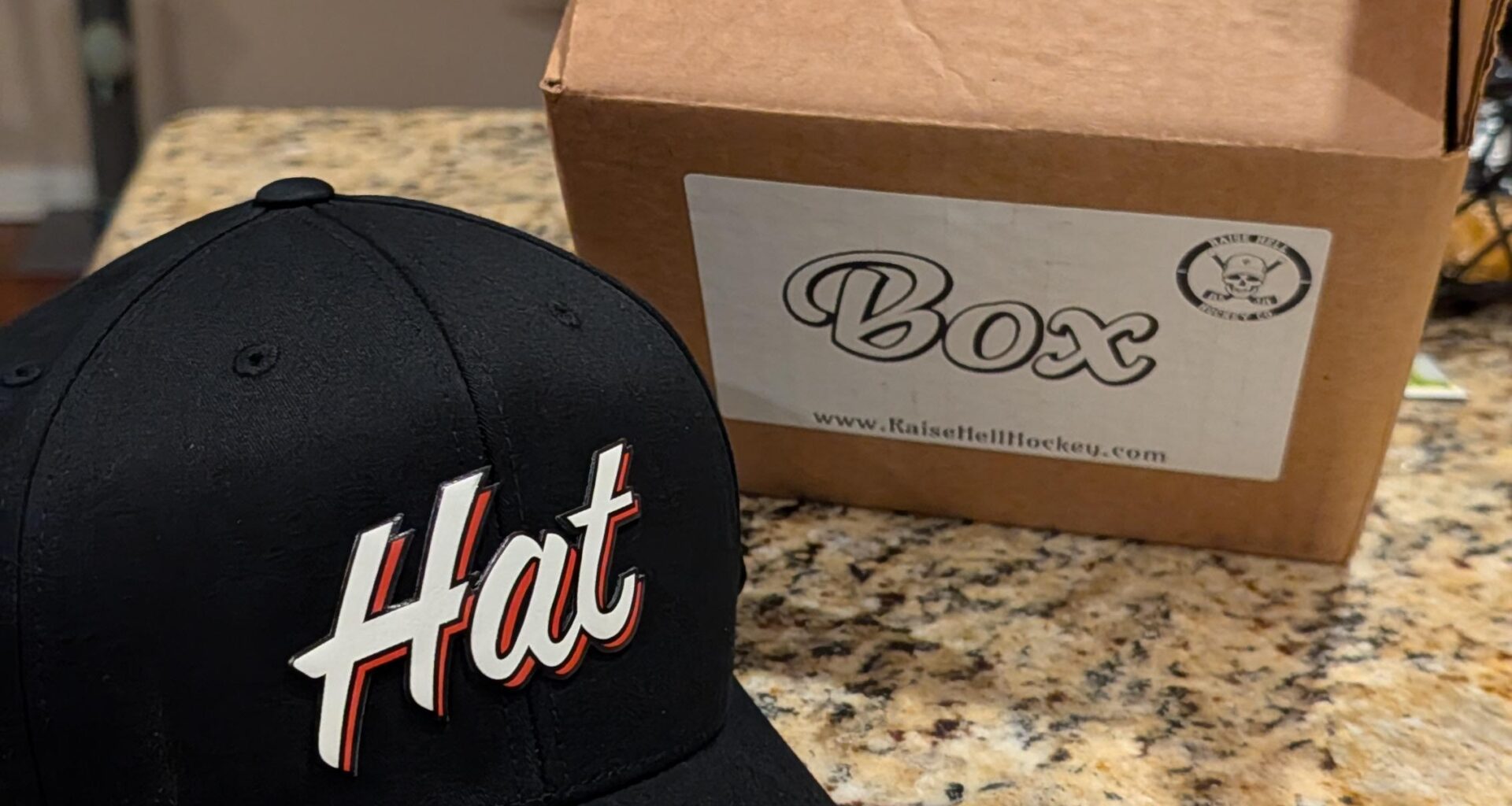 My "hat" hat came today in it's "box" box, sealed with "tape" tape, with a free "sticker" sticker!