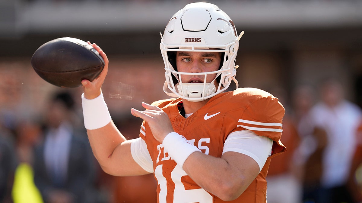 Texas Longhorns quarterback Arch Manning warming up on the field.