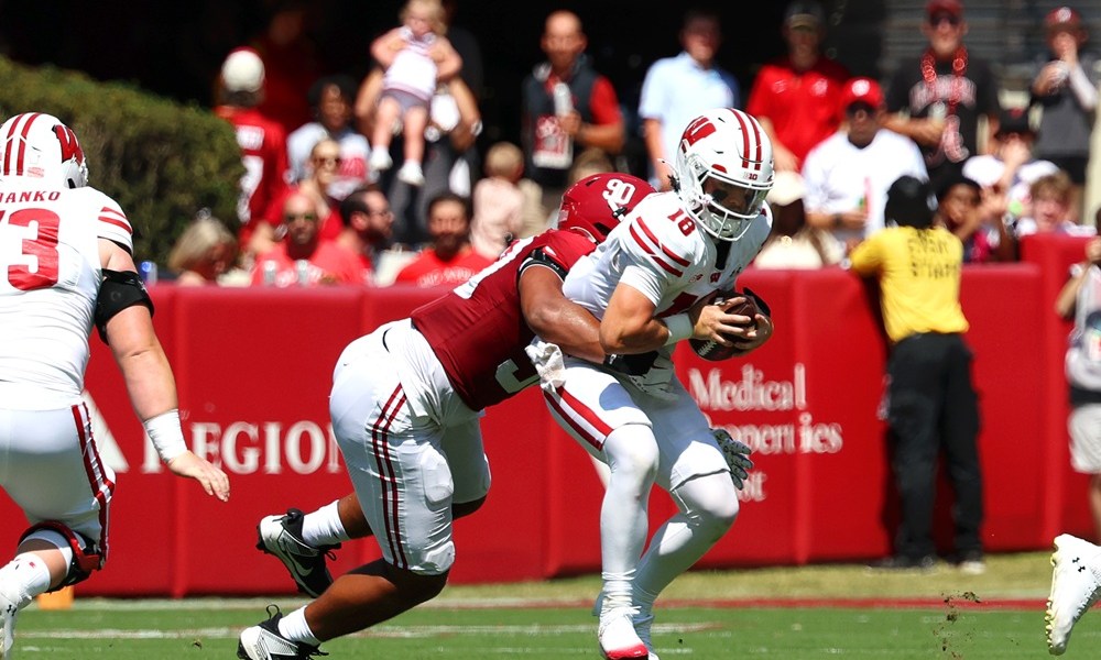 Alabama DL London Simmons (#90) sacks Wisconsin QB Danny O'Neil (#18) in 2025 game.