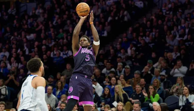 Feb 20, 2026; Minneapolis, Minnesota, USA; Minnesota Timberwolves guard Anthony Edwards (5) shoots over Dallas Mavericks guard Tyus Jones (1) in the third quarter at Target Center. Mandatory Credit: Matt Blewett-Imagn Images