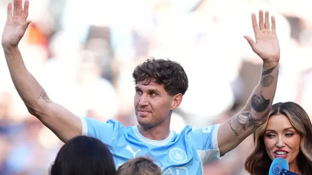 Manchester City's John Stones waves to the fans following his final appearance on Sunday