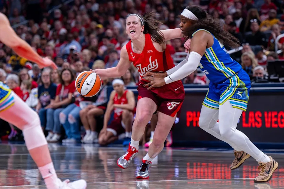 Fever guard Caitlin Clark (22) reacts as she makes contact with the defense of <a class="link " href="https://sports.yahoo.com/wnba/teams/dallas/" data-i13n="sec:content-canvas;subsec:anchor_text;elm:context_link" data-ylk="slk:Dallas Wings;sec:content-canvas;subsec:anchor_text;elm:context_link;itc:0" data-yga="{"yLinkElement":"context_link","yModuleName":"content-canvas","yLinkText":"Dallas Wings","ySubModuleName":"anchor_text","yHasCommerce":false}">Dallas Wings</a> guard <a class="link " href="https://sports.yahoo.com/wnba/players/6022/" data-i13n="sec:content-canvas;subsec:anchor_text;elm:context_link" data-ylk="slk:Arike Ogunbowale;sec:content-canvas;subsec:anchor_text;elm:context_link;itc:0" data-yga="{"yLinkElement":"context_link","yModuleName":"content-canvas","yLinkText":"Arike Ogunbowale","ySubModuleName":"anchor_text","yHasCommerce":false}">Arike Ogunbowale</a> (24) on May 9, 2026. AP
