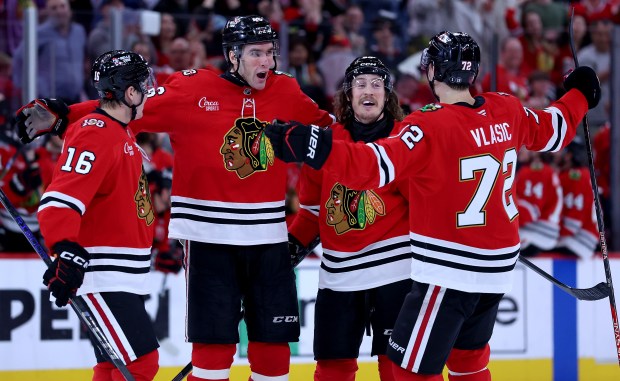 Blackhawks defenseman Louis Crevier, second from left, celebrates with teammates after scoring a goal in the third period against the Sharks on April 15, 2026, at the United Center. (Chris Sweda/Chicago Tribune)