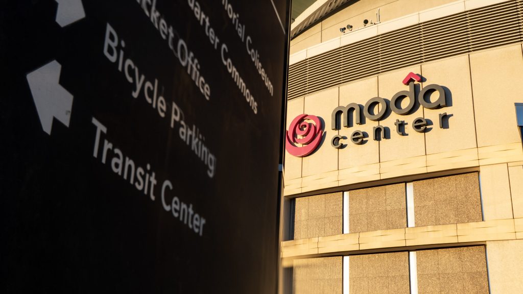 A sign in front of Moda Center says "Transit Center" next to an arrow pointing to the left
