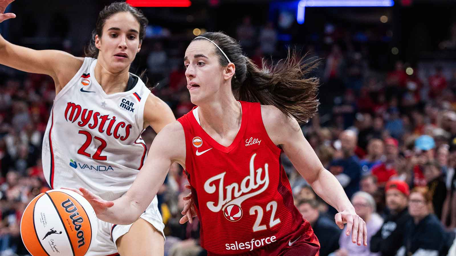 Indiana Fever guard Caitlin Clark (22) dribbles the ball while Washington Mystics guard Sonia Citron (22) defends in the second half at Gainbridge Fieldhouse.