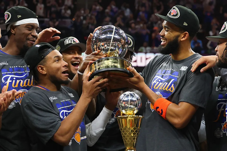 CLEVELAND, OHIO – MAY 25: <a class="link " href="https://sports.yahoo.com/nba/players/5432/" data-i13n="sec:content-canvas;subsec:anchor_text;elm:context_link" data-ylk="slk:Karl-Anthony Towns;sec:content-canvas;subsec:anchor_text;elm:context_link;itc:0" data-yga="{"yLinkElement":"context_link","yModuleName":"content-canvas","yLinkText":"Karl-Anthony Towns","ySubModuleName":"anchor_text","yHasCommerce":false}">Karl-Anthony Towns</a> #32 and <a class="link " href="https://sports.yahoo.com/nba/players/6578/" data-i13n="sec:content-canvas;subsec:anchor_text;elm:context_link" data-ylk="slk:Miles McBride;sec:content-canvas;subsec:anchor_text;elm:context_link;itc:0" data-yga="{"yLinkElement":"context_link","yModuleName":"content-canvas","yLinkText":"Miles McBride","ySubModuleName":"anchor_text","yHasCommerce":false}">Miles McBride</a> #2 of the New York Knicks celebrate with the Bob Cousy Trophy after defeating the Cleveland Cavaliers 130-93 in Game Four of the NBA Eastern Conference Finals at Rocket Arena on May 25, 2026 in Cleveland, Ohio. (Photo by Gregory Shamus/Getty Images)
