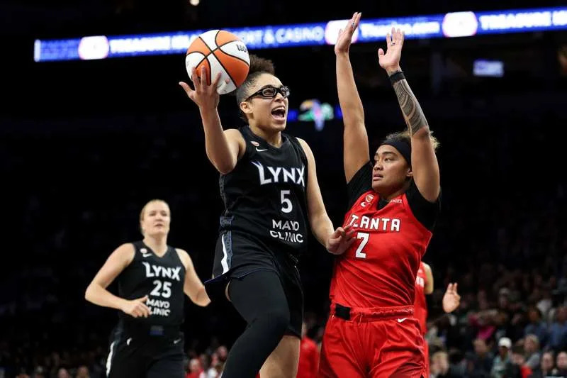 May 9, 2026; Minneapolis, Minnesota, USA; Minnesota Lynx guard Olivia Miles (5) shoots as Atlanta Dream guard Te-Hina Paopao (2) defends during the second half at Target Center. Mandatory Credit: Matt Krohn-Imagn Images