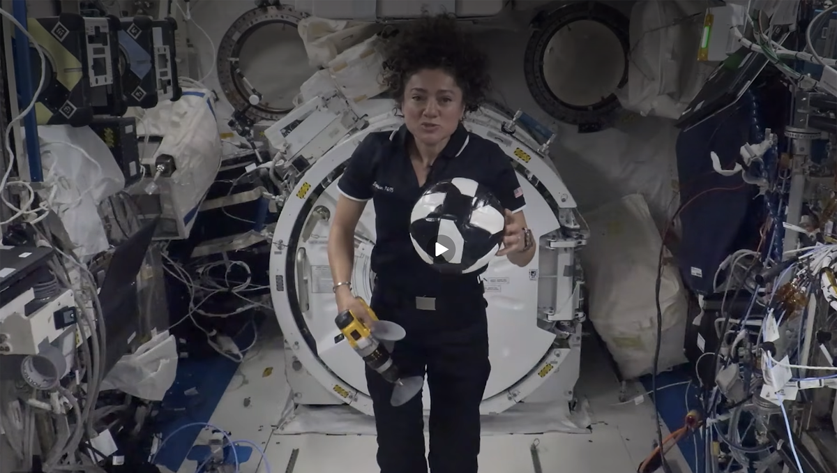 Astronaut shows off low gravity demonstration with soccer balls