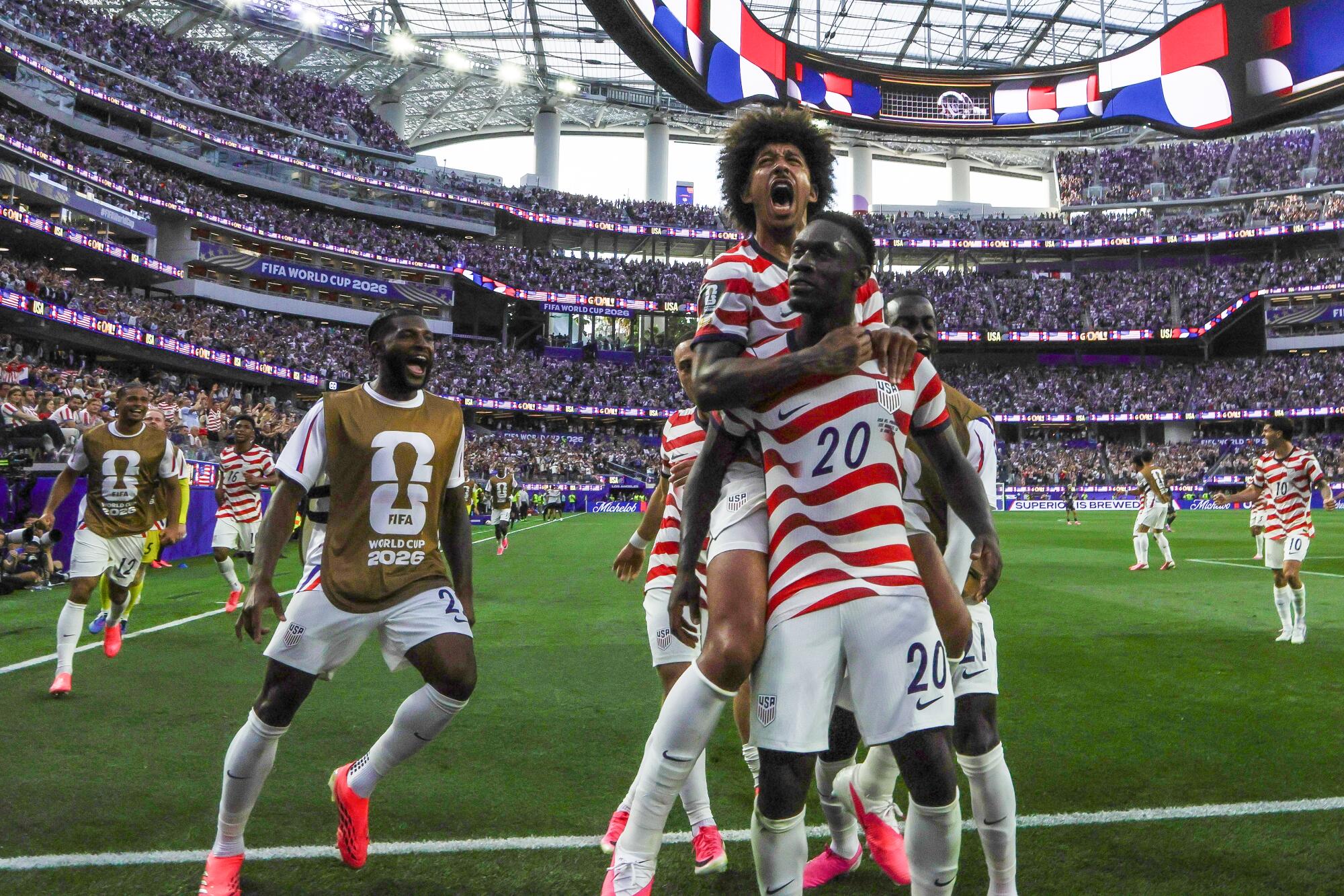 U.S. forward Folarin Balogun (20) celebrates with teammates after scoring against Paraguay.