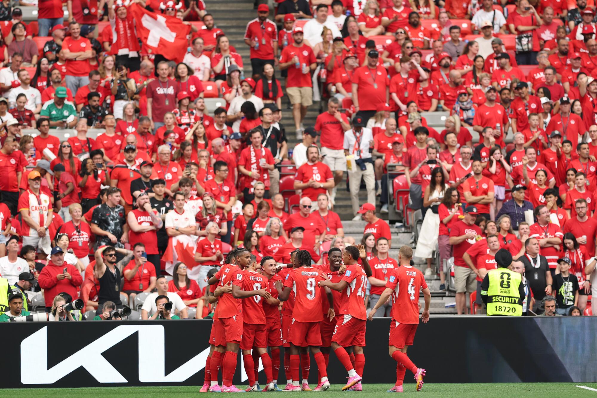 Switzerland's Rubén Vargas celebrates with teammates and fans after scoring against Canada during a World Cup match.