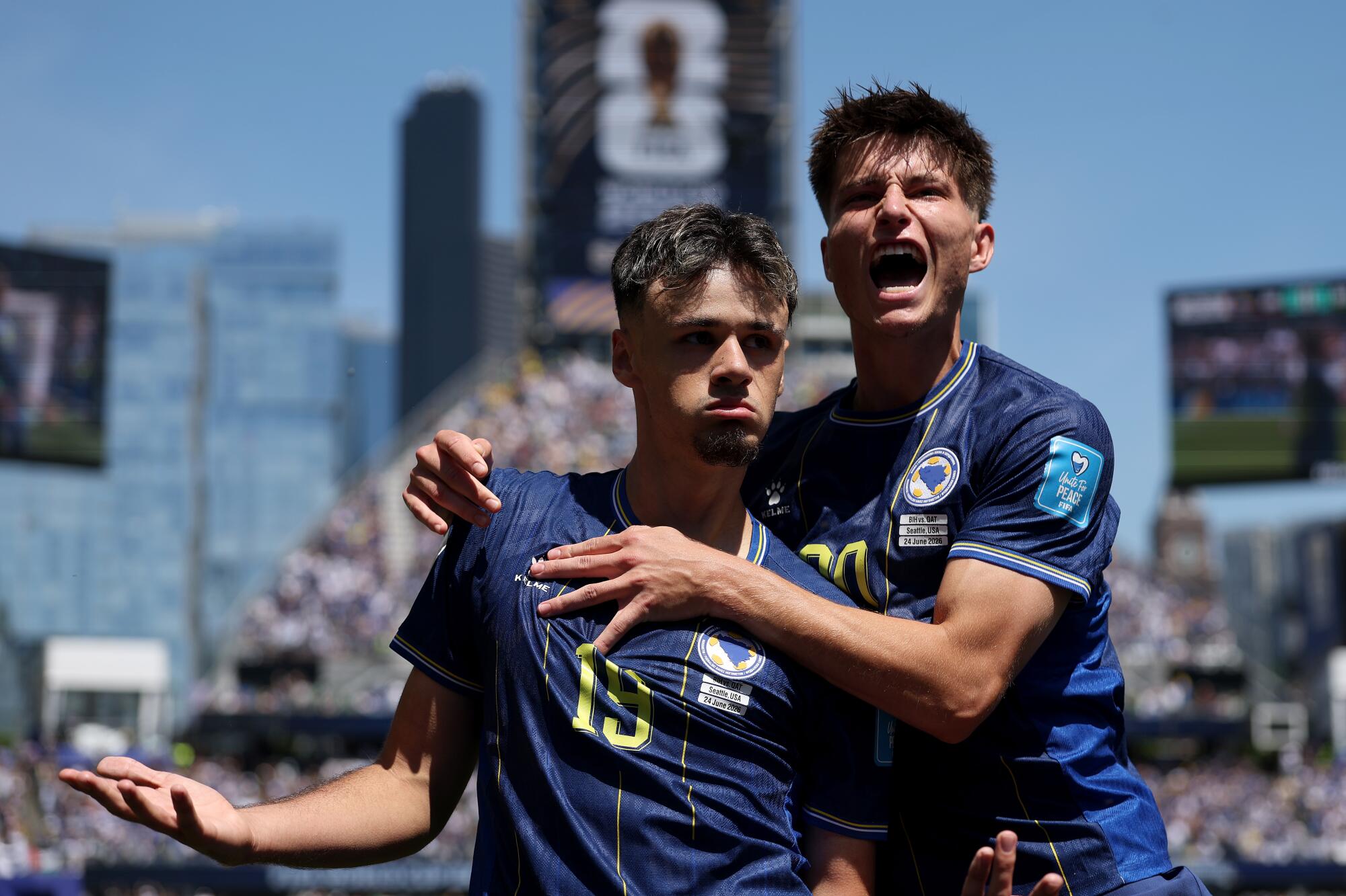 Bosnia and Herzegovina's Kerim Alajbegovic celebrates with Esmir Bajraktarevic after scoring during a World Cup match.
