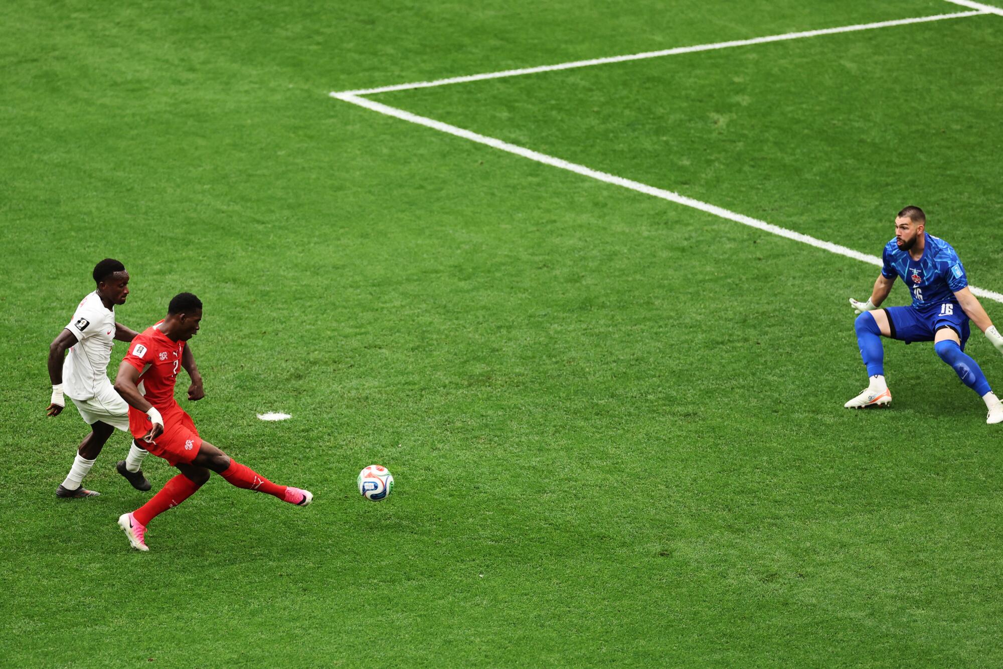 Switzerland's Breel Embolo takes a shot on Canada goalkeeper Maxime Crepeau during a World Cup match.