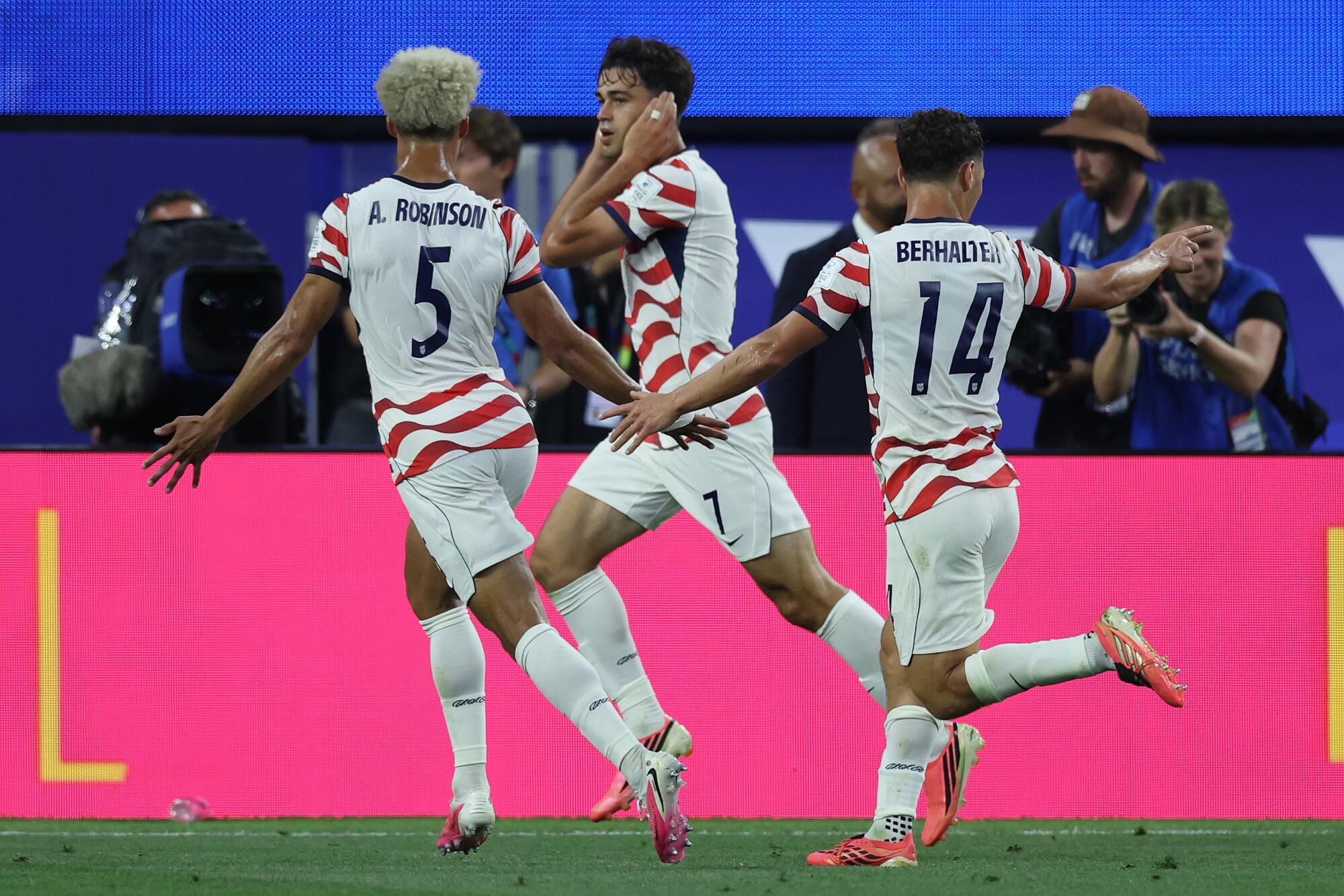 U.S. midfielder Gio Reyna celebrates with teammates Antonee Robinson and Sebastian Berhalter after scoring.