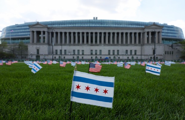 Chicago and U.S. flags are planted on the grass across the street from Soldier Field on April 23, 2026, in Chicago. (John J. Kim/Chicago Tribune)