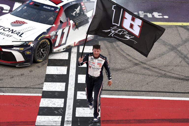 Denny Hamlin with the Kyle Busch flag - Michigan International Speedway - NASCAR Cup Series