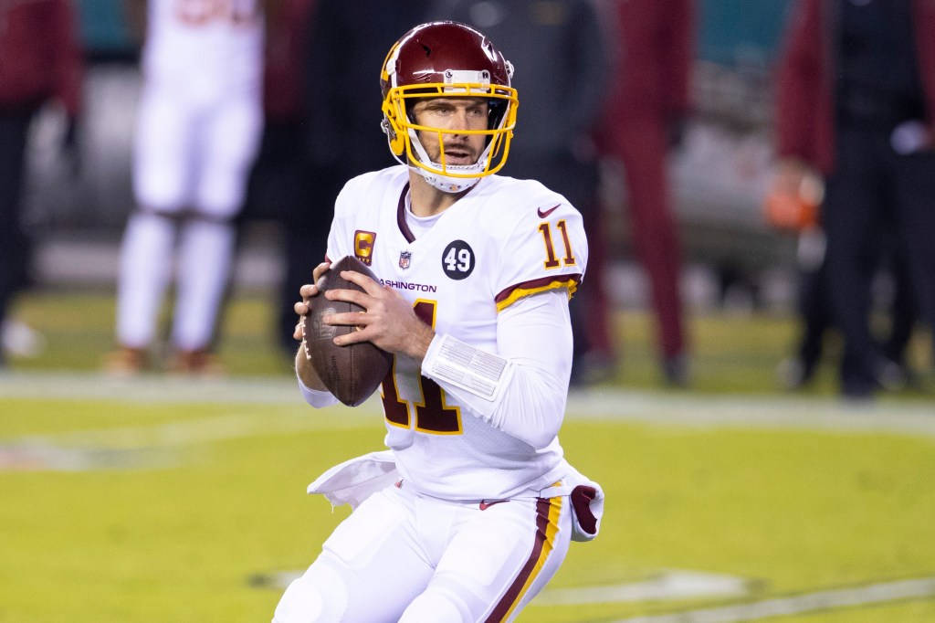 Alex Smith in a white Washington Football Team uniform, holding a football.