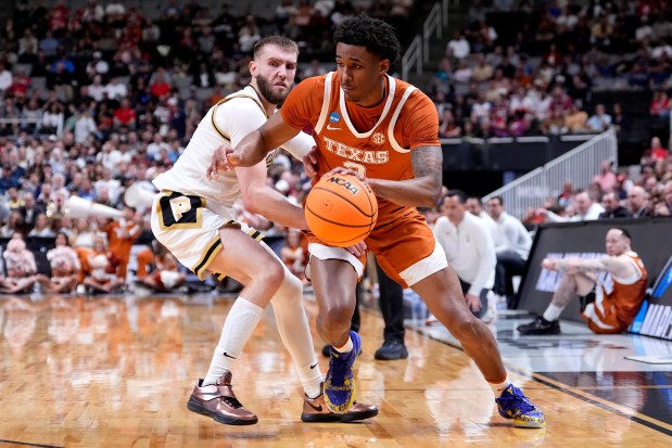 Dailyn Swain (3) of the Texas Longhorns dribbles the ball against Braden Smith #3 of the Purdue Boilermakers during the first half in the Sweet Sixteen of the 2026 NCAA Men's Basketball Tournament at SAP Center on March 26, 2026 in San Jose, California. (Photo by Thearon W. Henderson, Getty Images)