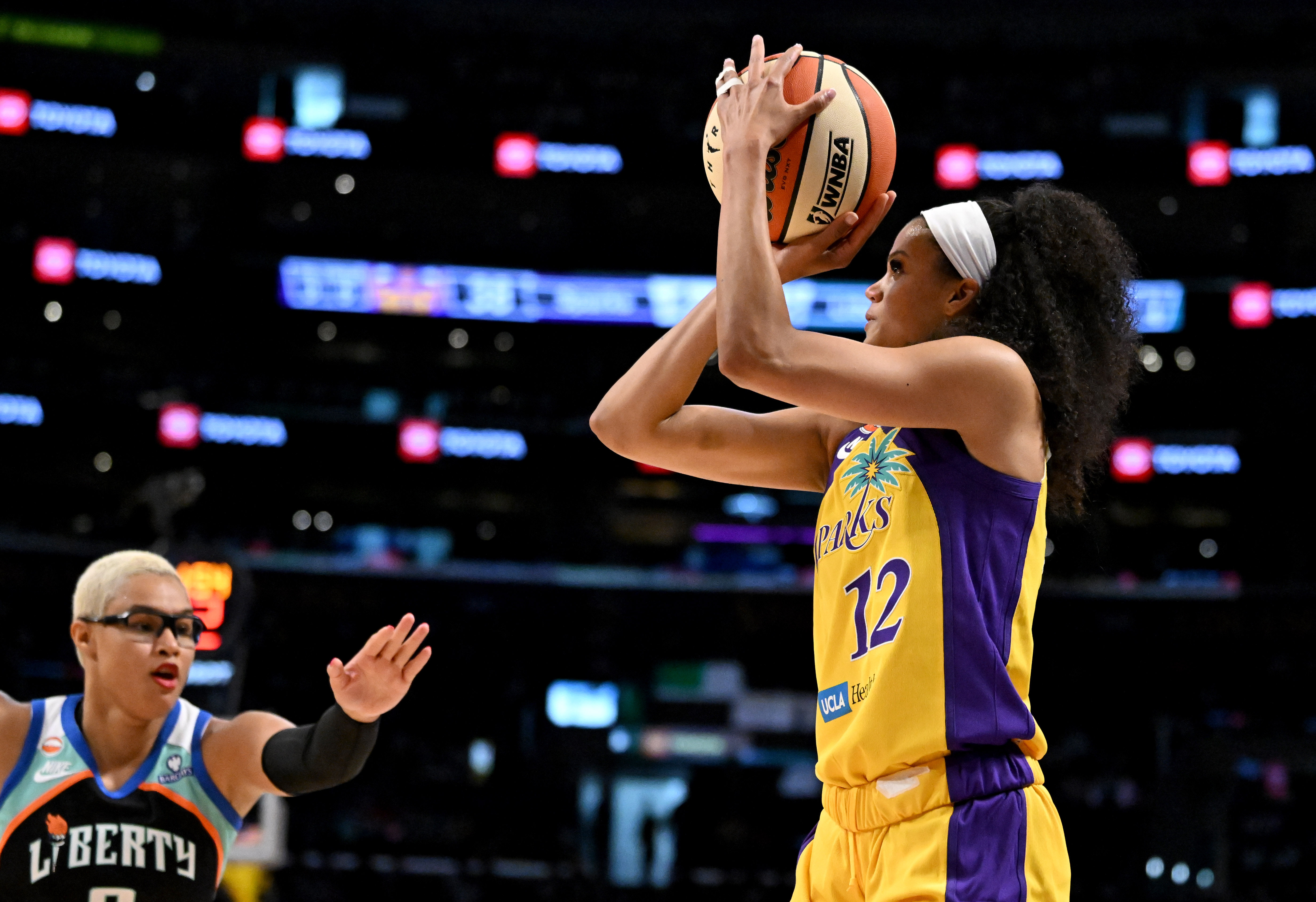 Sparks guard-forward Rae Burrell (12) takes a three point shot...