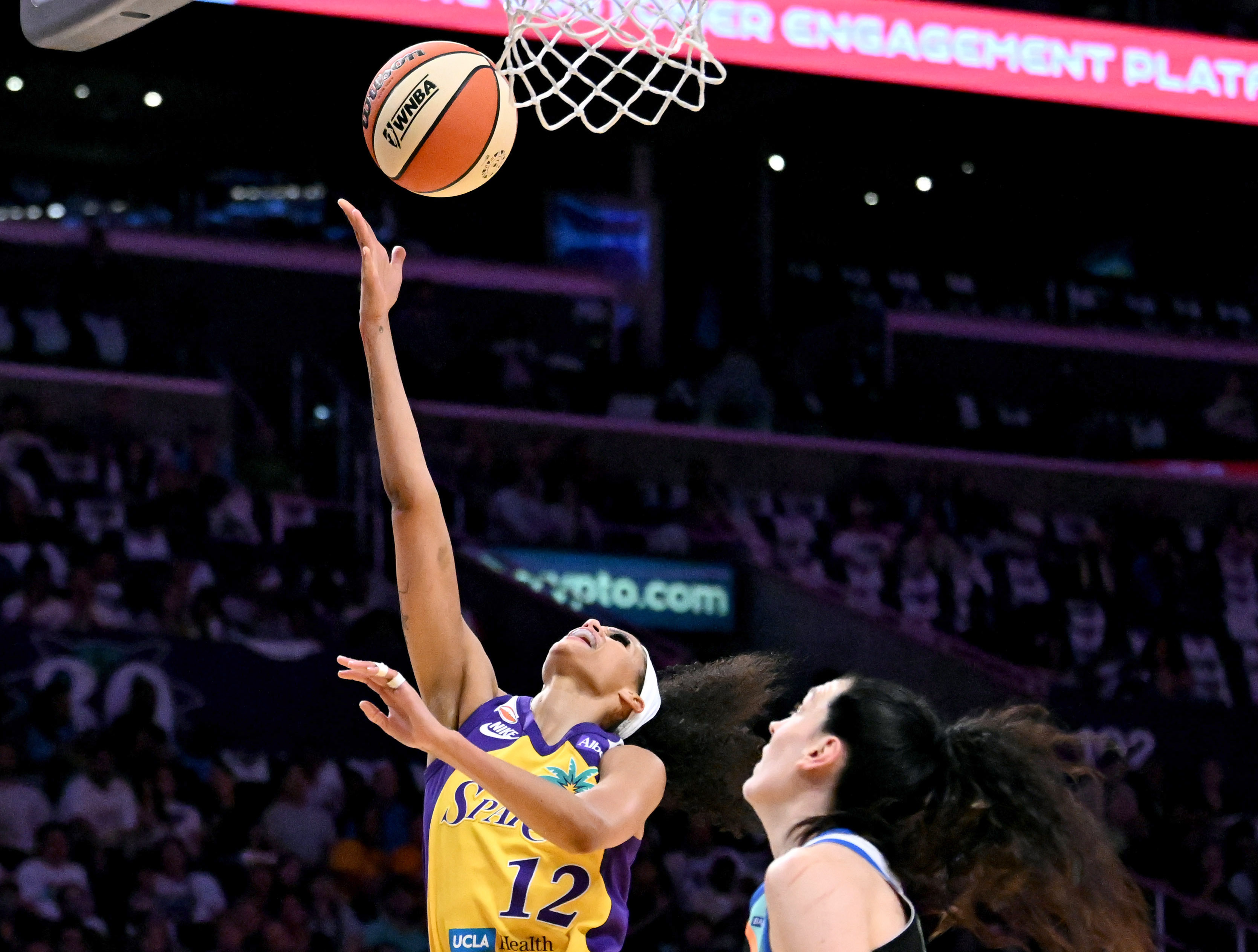 Sparks guard-forward Rae Burrell (12) drives to the basket in...