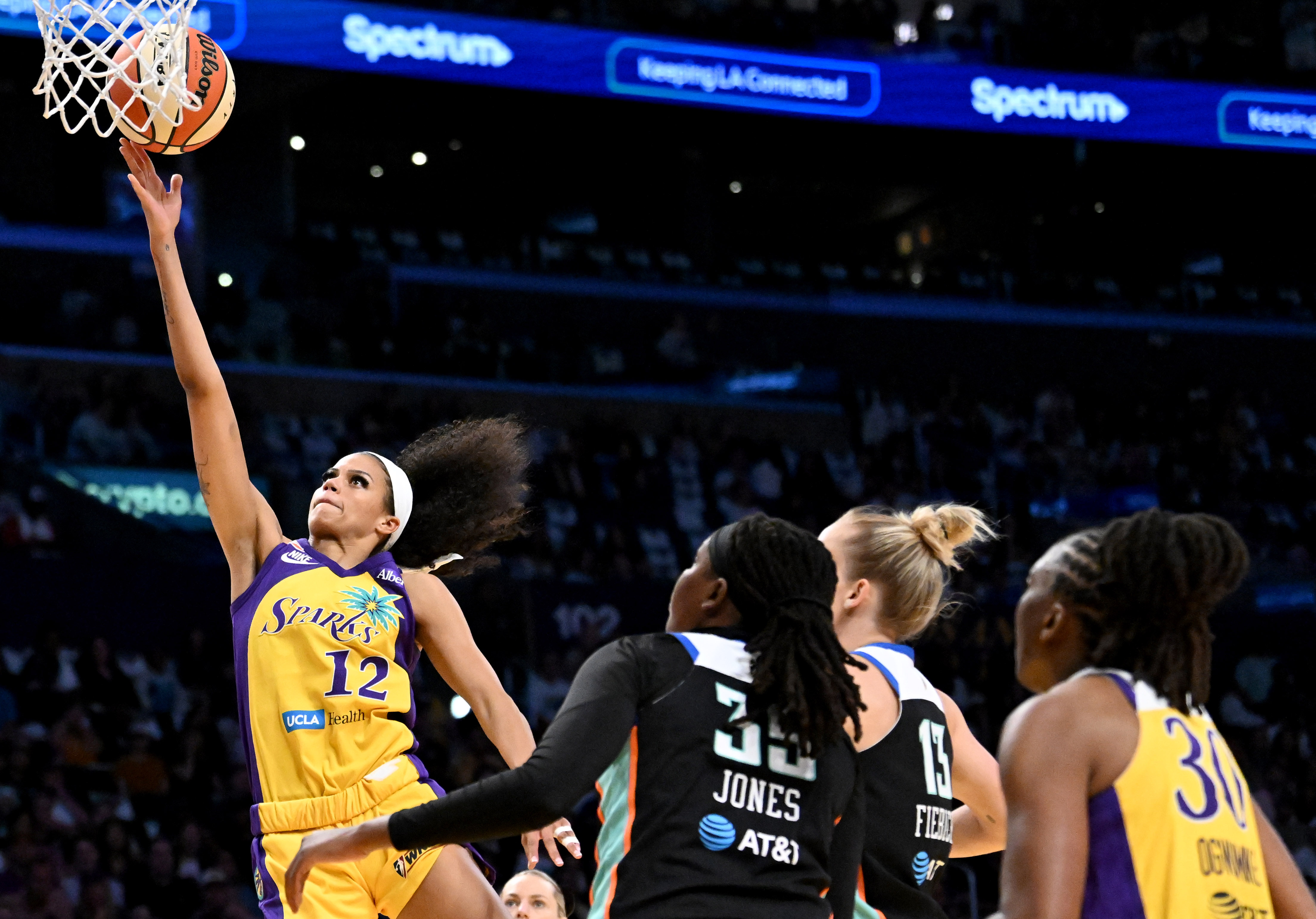 Sparks guard-forward Rae Burrell (12) takes a shot past New...