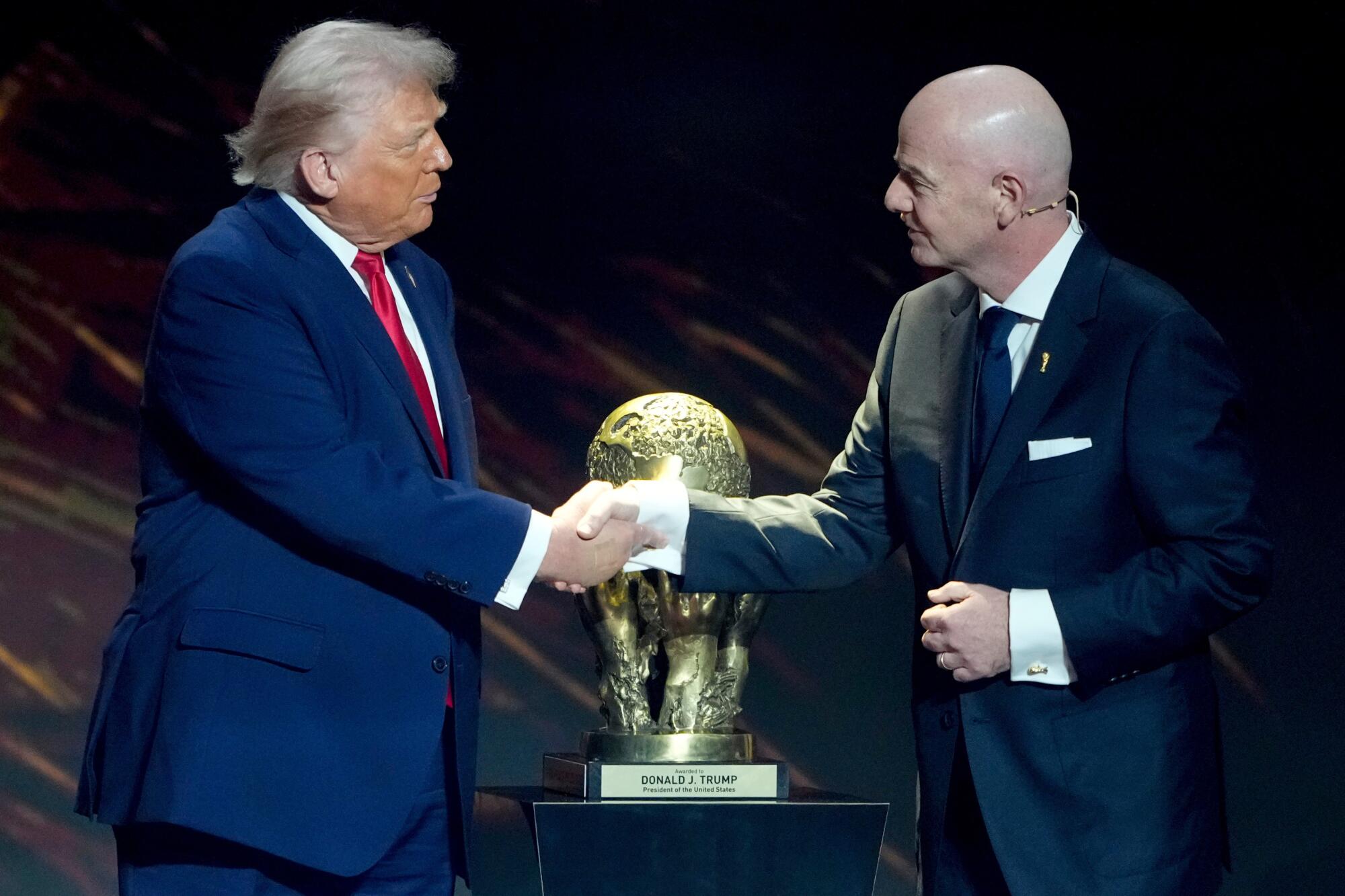 FIFA President Gianni Infantino gives President Donald Trump the FIFA Peace Prize at the Kennedy Center on Dec. 5, 2025.