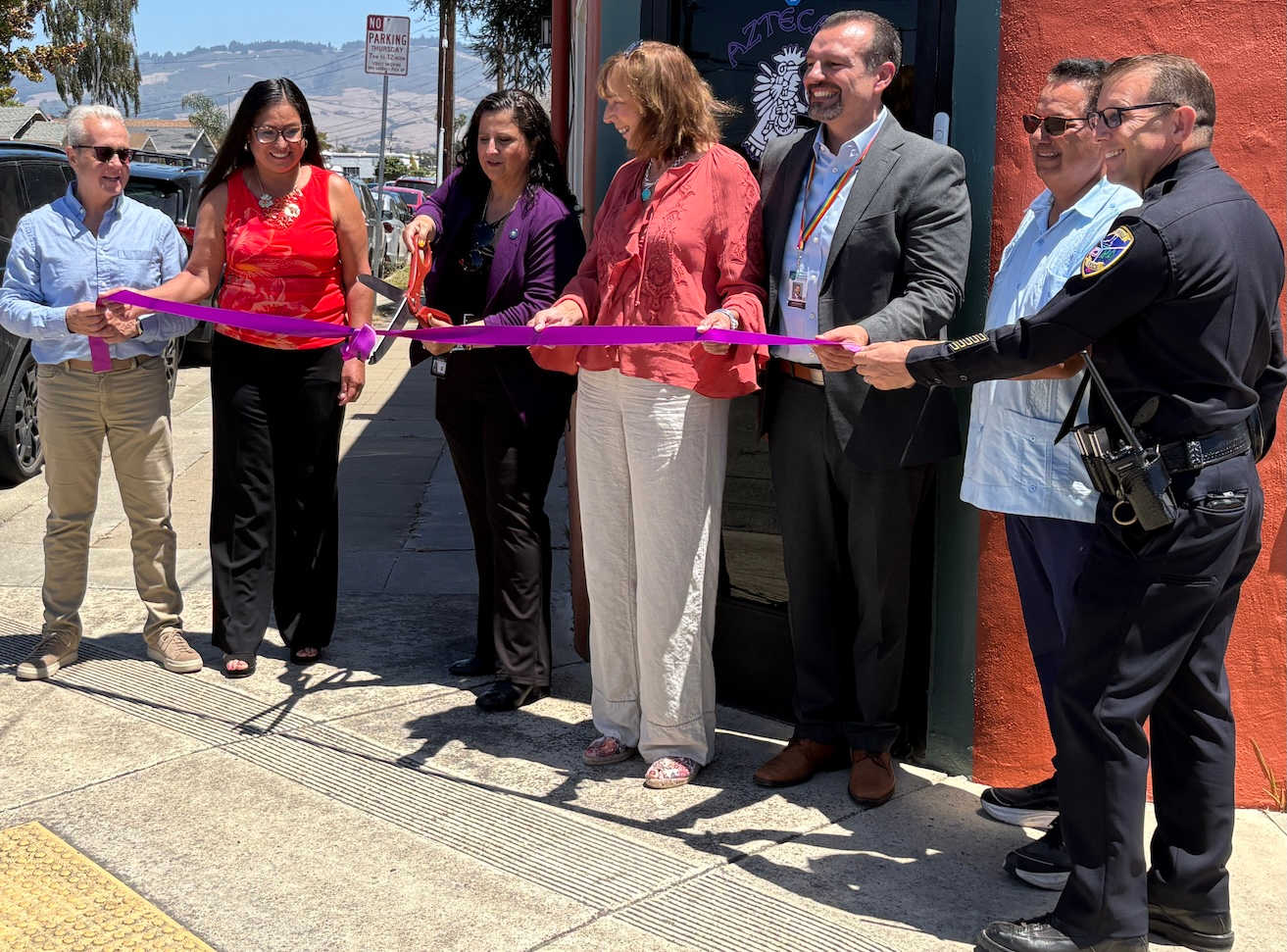 Santa Cruz County District Attorney Jeff Rosell, left, joins Aztecas Youth Soccer Academy founder Gina Castañeda, Chief Probation Officer Sandra Mendez, 1440 Multiversity co-creator Joanie Kriens, Santa Cruz County Superintendent of Schools Faris Sabbah, Ramon Gomez from Santa Cruz County Supervisor Felipe Hernandez’s office and Watsonville Police Chief Brian Shab in a ribbon-cutting ceremony at Aztecas new clubhouse.