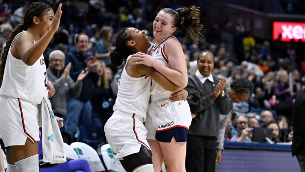 UConn guard KK Arnold, center, and UConn forward Sarah Strong, left, greet UConn guard Allie Ziebell as she comes out of the game in the second half of an NCAA college basketball game against Xavier, Wednesday, Jan. 28, 2026, in Storrs, Conn. (AP Photo/Jessica Hill)