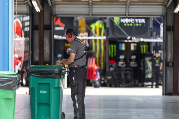 A crew member uses a trash bin as a table as he gets lunch before qualifying for the NASCAR eero 400 at Chicagoland Speedway on Saturday, July 4, 2026, in Joliet. (Vincent D. Johnson/For the Daily Southtown)