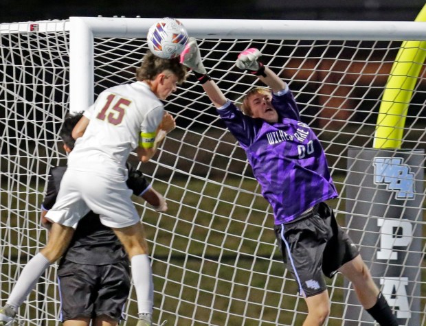 Wilkes-Barre Area goalkeeper Dylan Parry, right, blocks a header by Wyoming Valley West's Luke Ginochetti in a boys soccer game at Wolfpack Stadium in Plains Twp. on Tuesday, Sept. 30, 2025. BILL TARUTIS / CONTRIBUTING PHOTOGRAPHER