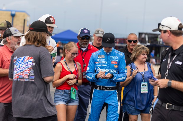 Denny Hamlin signs autographs for fans after winning the pole during qualifying for the NASCAR eero 400 at Chicagoland Speedway in Joliet on Saturday, July 4, 2026. (Vincent D. Johnson / for the Daily Southtown)