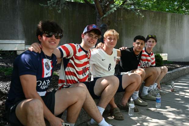 Young people from Dunmore gather in a shady area Saturday, July 4, 2026, during the World Cup Fan Zone event. (GERI GIBBONS/STAFF PHOTO)