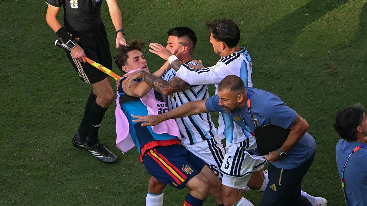 Spain and Argentina players scuffle on the field after the match in East Rutherford.