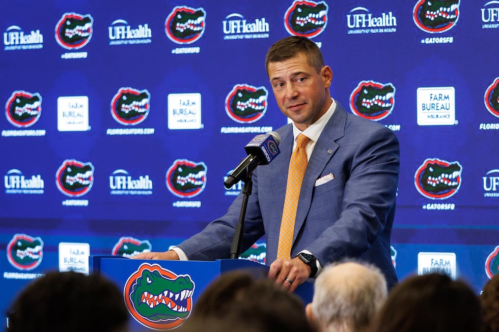 FILE - New Florida NCAA college football head coach Jon Sumrall speaks during a news...