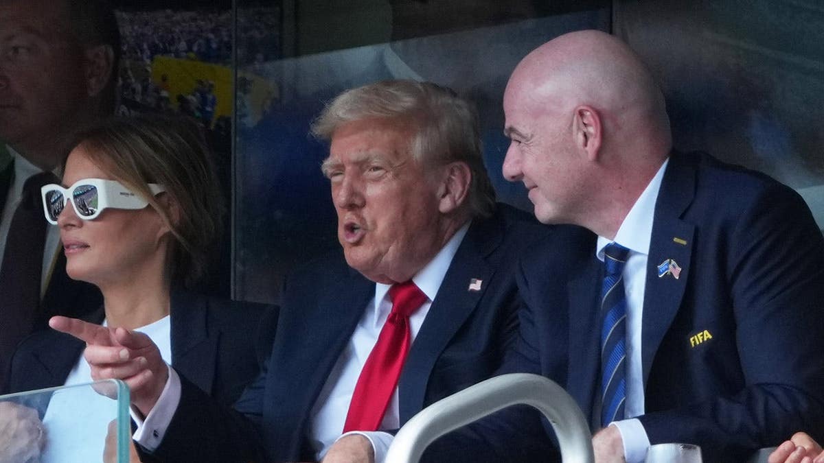 Donald Trump and Melania Trump attend a match with Gianni Infantino at a stadium.