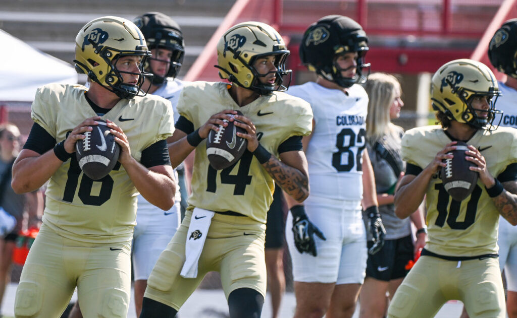 Colorado quarterbacks Isaac Wilson (16), Kaneal Sweetwyne (14), and Julian Lewis (10) look down the field before throwing the ball  during a practice at the Fountain-Ft. Carson High School field on Thursday, Aug. 6, 2026. (Jerilee Bennett, The Gazette)