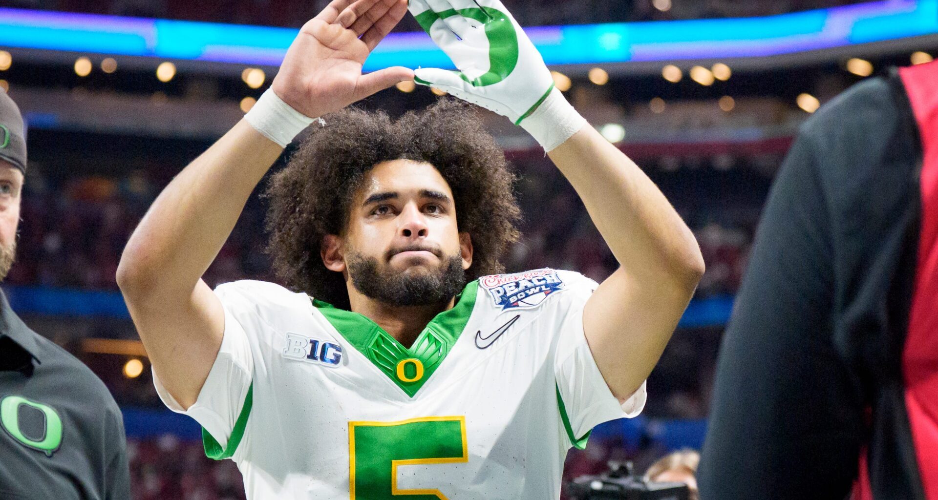 Oregon quarterback Dante Moore walks off the field as the Oregon Ducks face the Indiana Hoosiers in the Peach Bowl on Jan. 9,