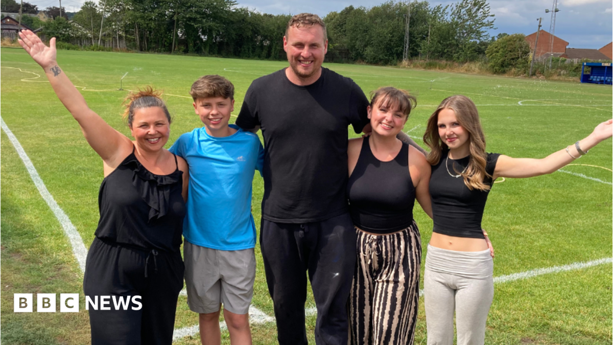 The Stockdale family from left to right - Katie, Billy, David, Mollie and Daisy - are standing on the pitch at Farsley FC with their arms around each other