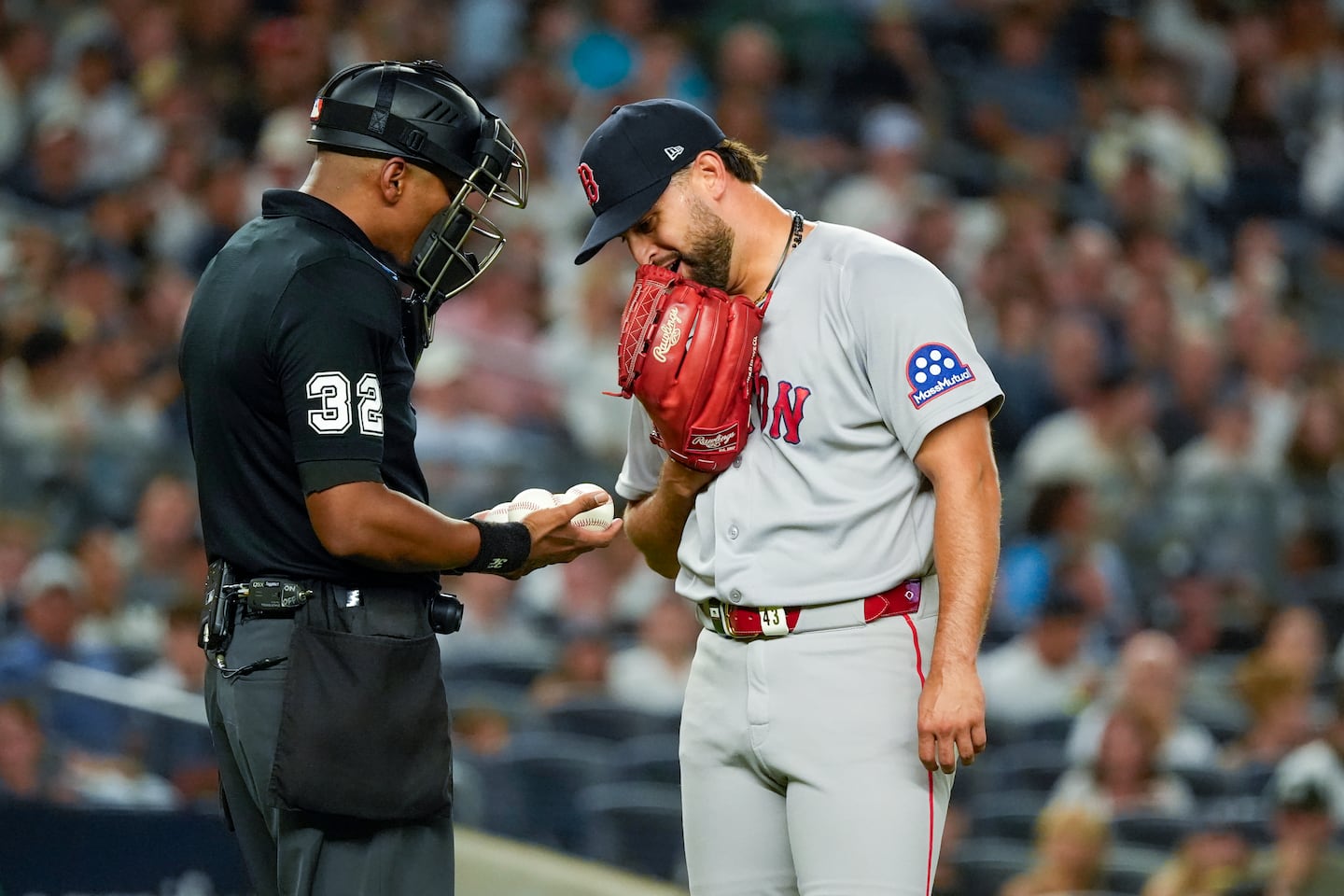 Umpire Edwin Moscoso gives Sox starter Patrick Sandoval a choice of which ball he wants to throw in the third inning of Friday night's 1-0 loss to the Yankees at the Stadium.