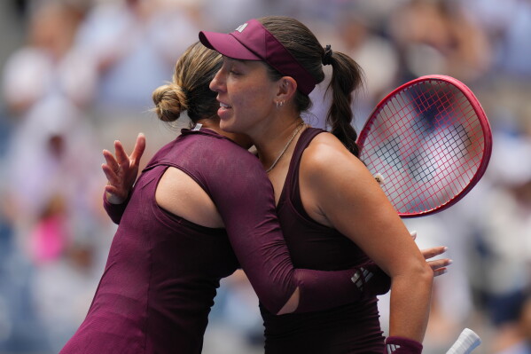 Jessica Pegula, of the United States, right, embraces Elena-Gabriela Ruse, of Romania, after Pegula won the first round of the U.S. Open tennis championships Sunday, Aug. 30, 2026, in New York. (AP Photo/Kirsty Wigglesworth)