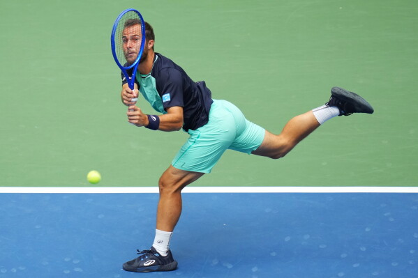 Hugo Gaston, of France, returns the ball to Daniil Medvedev, of Russia, during the first round of the U.S. Open tennis championships Sunday, Aug. 30, 2026, in New York. (AP Photo/Kirsty Wigglesworth)