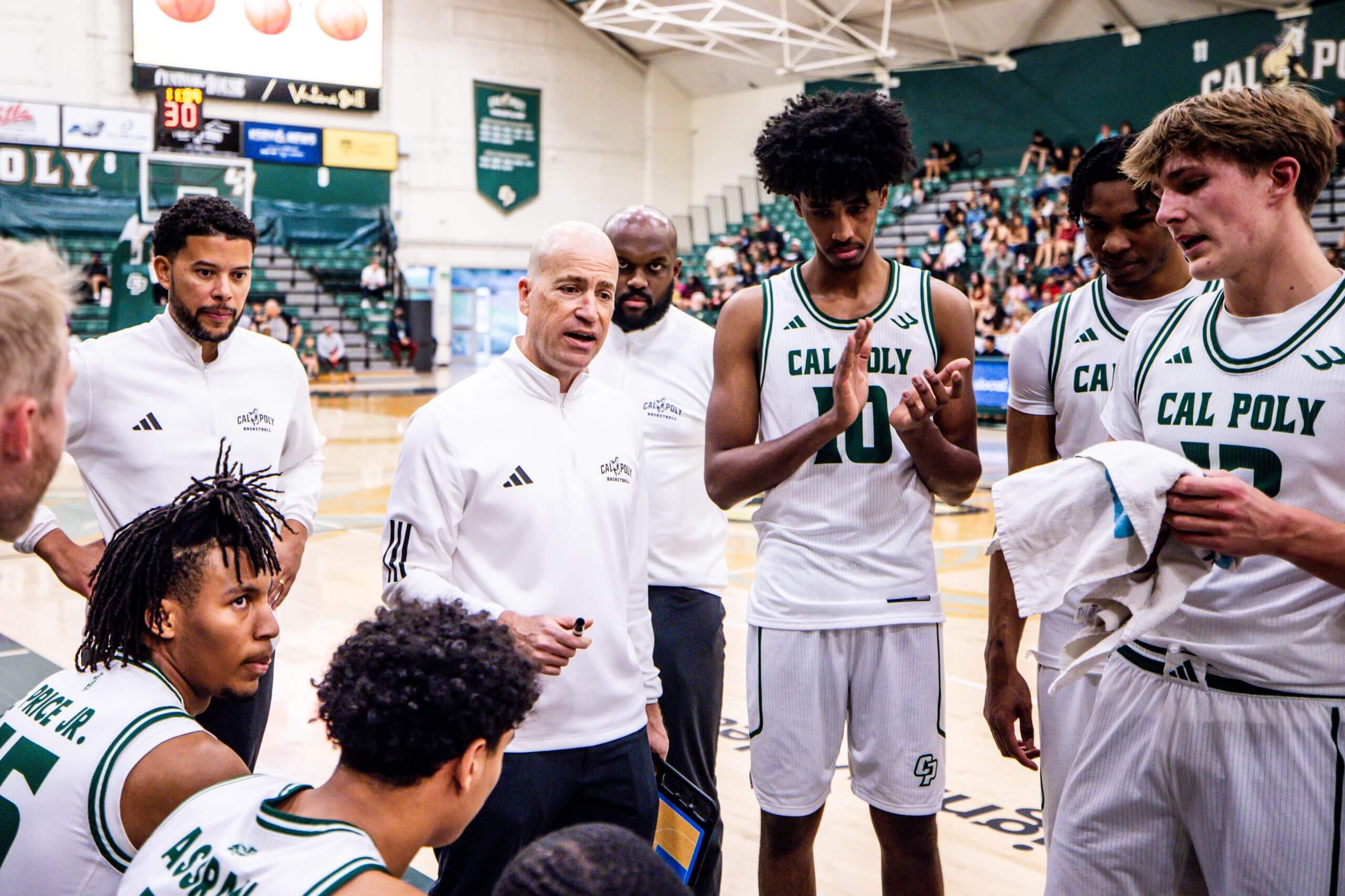 Coach Mike DeGeorge talks to his team in the huddle.