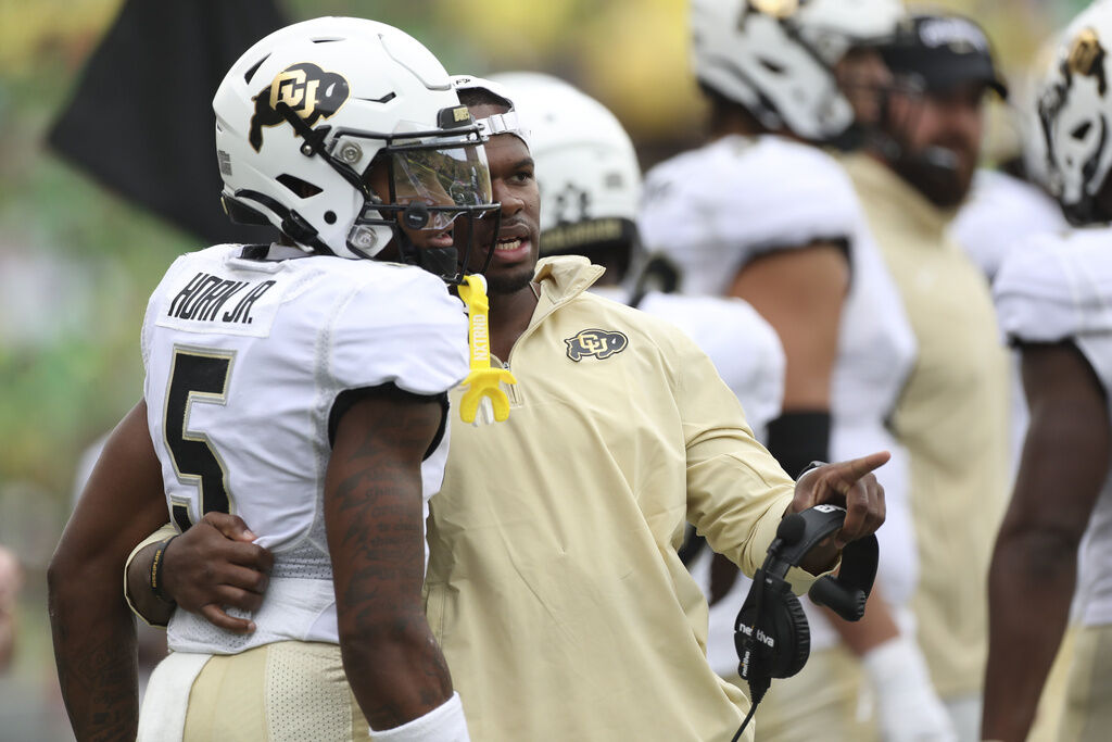 Colorado wide receiver Jimmy Horn Jr. talks with Colorado offense quality control analyst Rashad Davis during an NCAA football game against Oregon, Saturday, Sept. 23, 2023, in Eugene, Ore. Oregon won 42-6. (AP Photo/Amanda Loman)