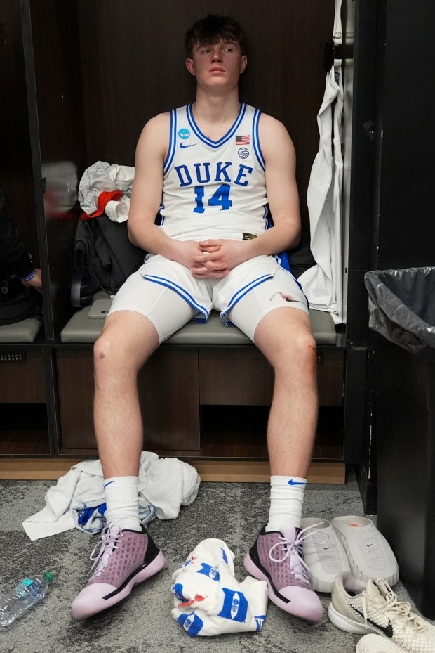 Duke guard Nikolas Khamenia sits in the locker room after their Elite Eight game of the NCAA college basketball tournament against UConn, Sunday, March 29, 2026, in Washington. (AP Photo/Stephanie Scarbrough)