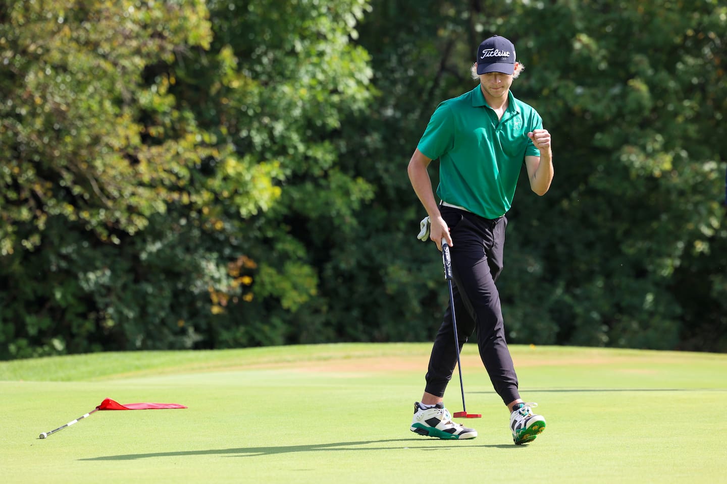 Bishop McNamara's Braylon Ricketts celebrates making a putt during the IHSA Class 1A Kankakee (McNamara) Regional at the Kankakee Elks Country Club on Wednesday, Oct. 1, 2025. Payne would finish sixth overall with a score of 85 to help the Fightin' Irish team claim the regional title for the first time since 2010.