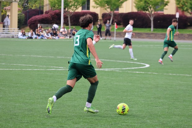 Defender Robert Somerville dribbles down the field. (Max Combs)