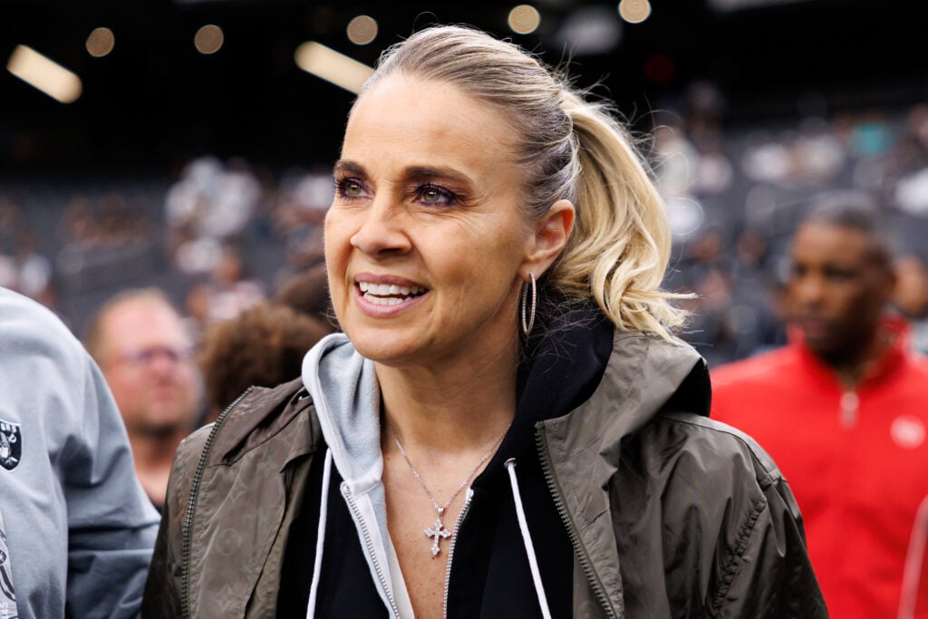Head coach Becky Hammon of the Las Vegas Aces stands on the sidelines prior to an NFL football game between the Tennessee Titans and the Las Vegas Raiders at Allegiant Stadium.